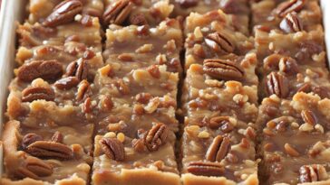 Golden baked Caramel Pecan Dream Bars in a pan.