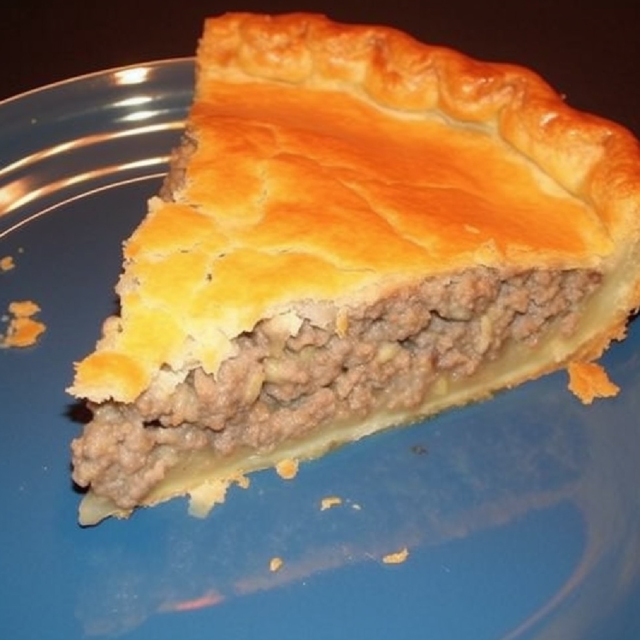 Serving a slice of savory French Meat Pie at family dinner