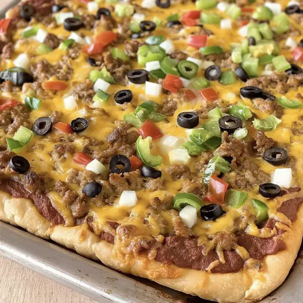 Discover the joy of Sheet Pan Taco Pizza, a perfect blend of savory taco flavors and crispy pastry delight. Dive into this family favorite recipe now!