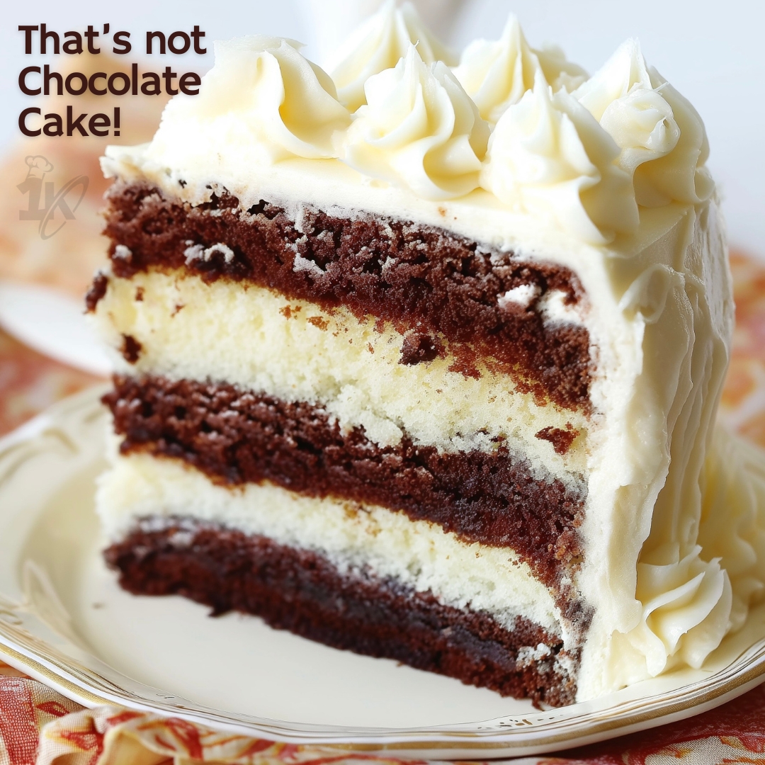 Close-up of white layer cake with decadent fudgy brownie, perfect for celebrations.
